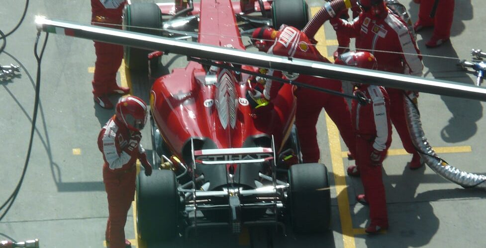 Race Driver Refuels at Pit Stop to Rejoin the Track