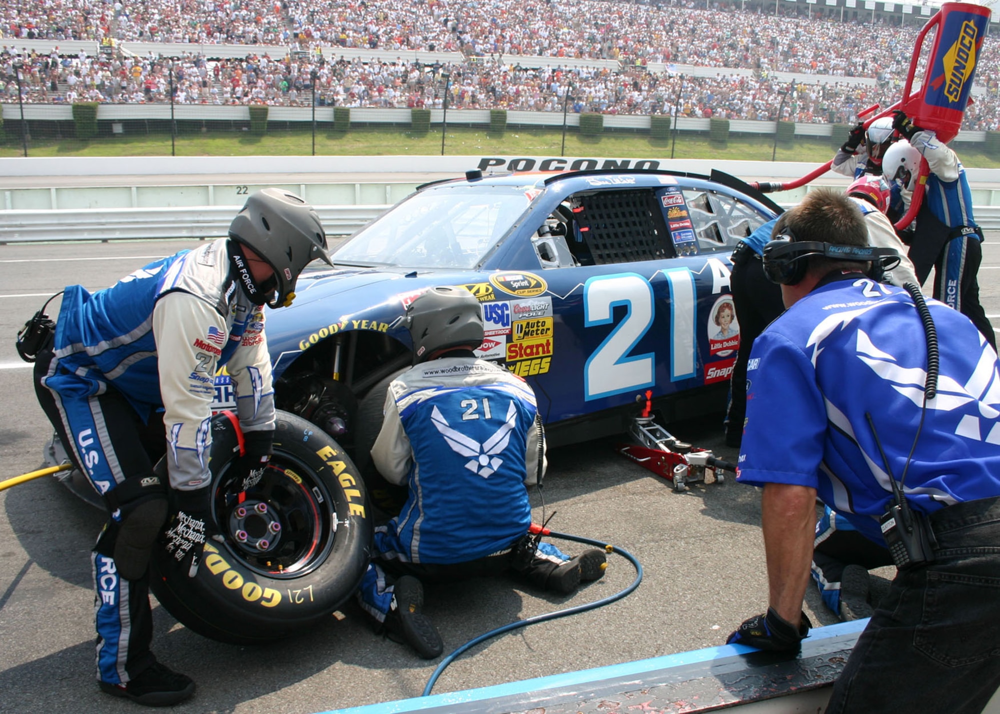 Race Driver Refuels at Pit Stop to Rejoin the Track